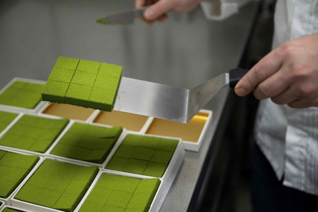 Japanese chocolatier Yasushi Sasaki prepares green tea chocolate ganaches in his workshop in the Brussels commune of Woluwe-Saint-Pierre on March 14, 2024. (AFP)