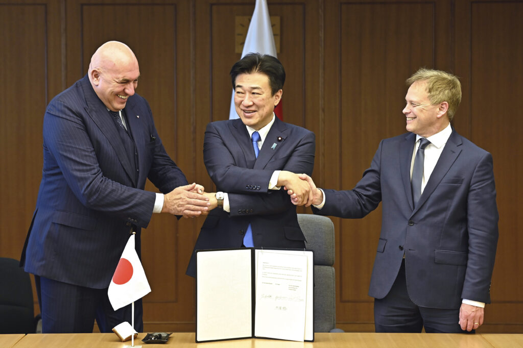 Britain's Defense Minister Grant Shapps, right, Italy's Defense Minister Guido Crosetto, left, and Japanese Defense Minister Minoru Kihara, center, shake hands after a signing ceremony for the Global Combat Air Programme (GCAP) at the defense ministry, Dec. 14, 2023. (AP)
