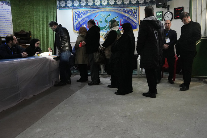 People queue to vote during the parliamentary and Assembly of Experts elections at a polling station in Tehran on March 1, 2024. (AP Photo/Vahid Salemi)