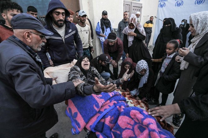 A Palestinian woman injured during overnight Israeli bombardment reacts as she is brought to Al-Aqsa hospital in Deir El-Balah in central Gaza on March 2, 2024, amid ongoing battles between Israel and the Palestinian militant group Hamas. (AFP)