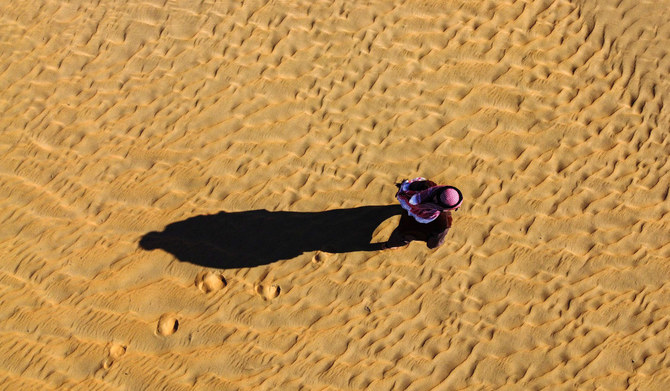 In this aerial view, an Iraqi camper walks on the sand in the Samawa desert south of Baghdad on February 2, 2024. (AFP)