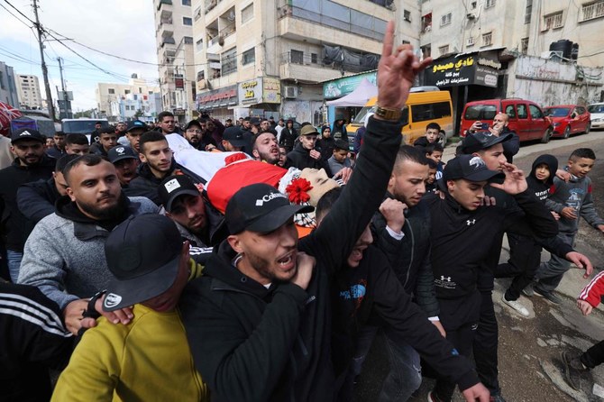 Palestinian mourners carry the body of 16-year-old Mustafa Abu Shalbak, who was shot before dawn by Israeli forces near Ramallah, during his funeral in Qalandiya refugee camp, West Bank. (AFP)