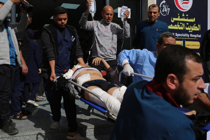 An injured man is transported on a stretcher at the Kuwaiti hospital following Israeli bombardment that hit a camp sheltering displaced Palestinians. (File/AFP)