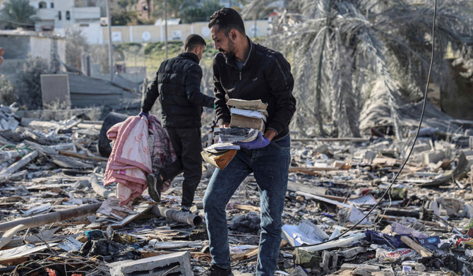 Palestinians search for their belongings amid the rubble of houses destroyed by Israeli bombardment in Rafah in the southern Gaza Strip on March 11, 2024, amid continuing battles between Israel and the Palestinian militant group Hamas. (AFP)