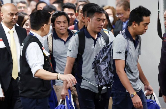 Filipino crewmen, who survived the deadly Houthi attack on the commercial ship ‘True Confidence,’ arrive at Manila International Airport, in Pasay, Metro Manila, Philippines, Mar. 12, 2024. (Reuters)