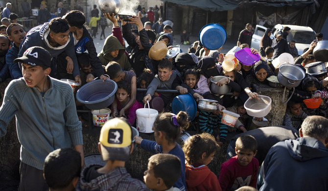 Palestinians line up for a free meal in Rafah, Gaza Strip, on Tuesday, March 12, 2024. (AP)