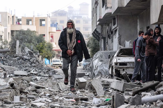 A man finds his way amid the rubble of a Palestinian family home after it was destroyed in an Israeli strike in Deir Al-Balah in the central Gaza Strip. (File/AFP)