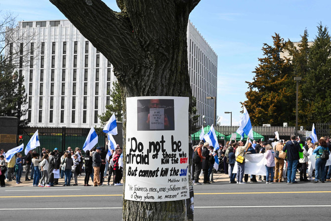 People take part in an anti-Putin rally as voters queue outside the Russian embassy in Washington, DC, on March 17, 2024. (AFP)