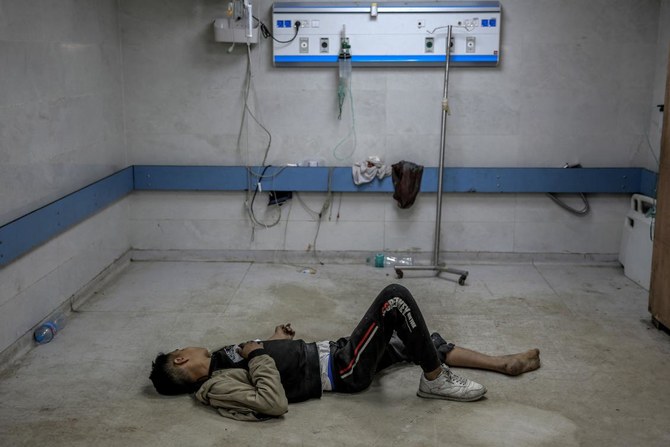 Tens of thousands of displaced Palestinians have sought shelter in the Al-Shifa hospital complex, which in November was attacked by Israel with tanks, drones and weapons. Above, a young man injured in Israeli bombardment awaits medical attention at the Al-Shifa hospital. (AFP)