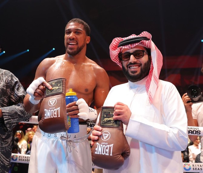 Two-time unified heavyweight world champion Anthony Joshua celebrates his victory over Francis Ngannou with Saudi entertainment authority cheif Turki Alalshikh. (Social Media)