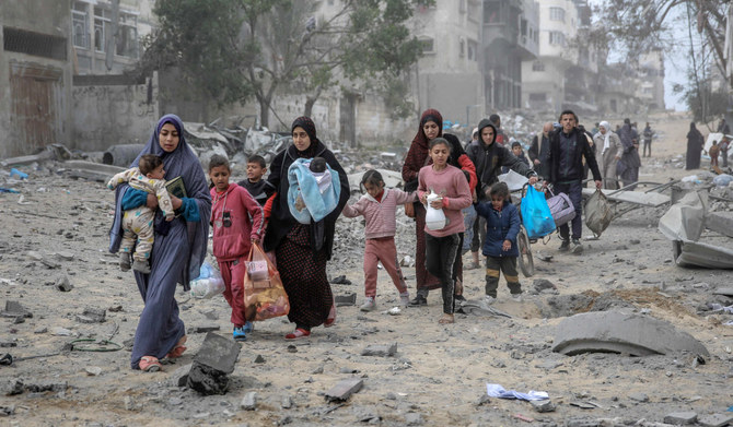 Palestinians flee the area after Israeli bombardment in central Gaza City on March 18, 2024, amid the ongoing battles between Israel and the militant group Hamas. (AFP)