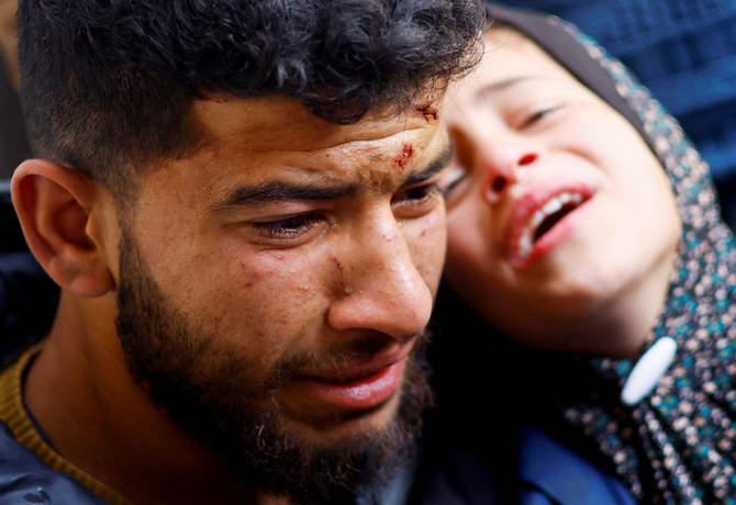 Mourners react next to the bodies of Palestinians killed in Israeli strikes, amid the ongoing conflict between Israel and Hamas, at a hospital in Rafah, in the southern Gaza Strip, March 19, 2024. (REUTERS)