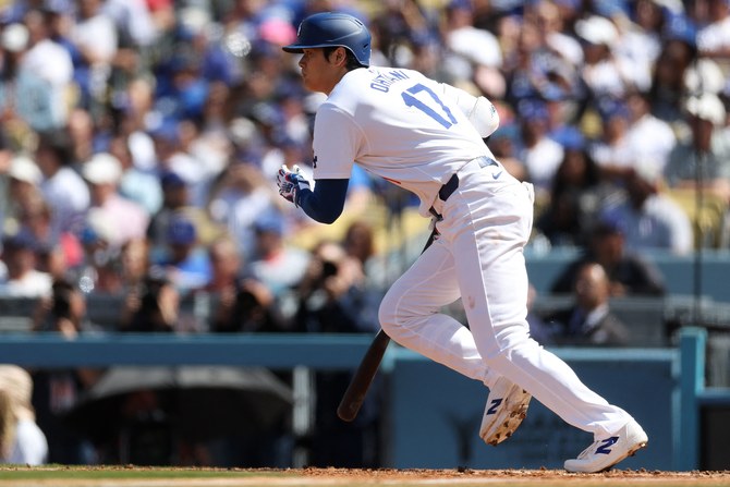 Shohei Ohtani of the Los Angeles Dodgers runs to first base after hitting a single during the fifth inning of a game against the St. Louis Cardinals at Dodger Stadium in Los Angeles, California. (File/AFP)