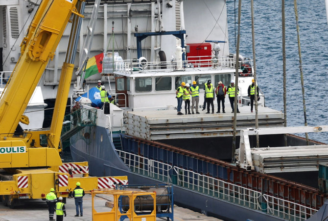 People inspect humanitarian aid for Gaza loaded on a cargo ship in the port of Larnaca, Cyprus March 15, 2024. (Reuters)