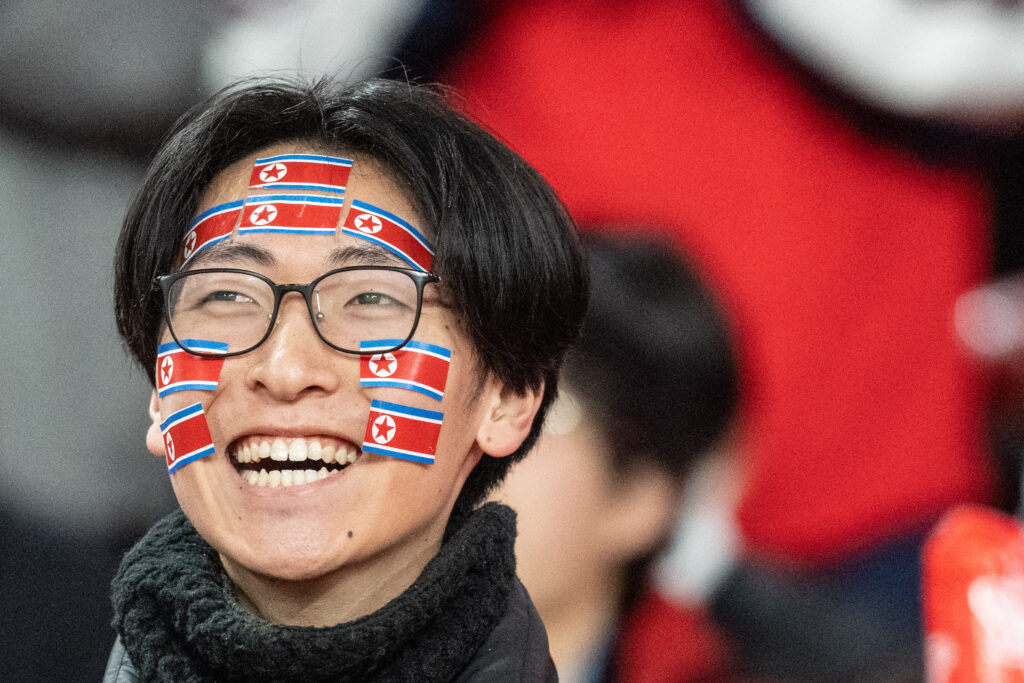 A North Korea fan reacts during the World Cup 2026 qualifier football match between Japan and North Korea at Tokyo's National Stadium on March 21, 2024.  (AFP)
