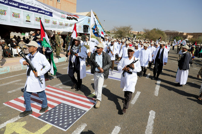 Health workers parade in Sanaa on March 9, 2024, as part of a Houthi mobilization drive. (Reuters)