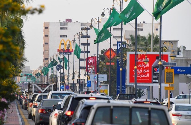 The green Saudi flag bears the “shahada,” the declaration of Muslim faith, inscribed above the sword. (SPA)