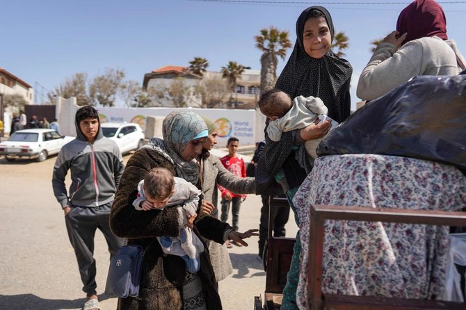 People who fled the Al-Shifa hospital and its vicinity in Gaza City board a vehicle to be driven from the central Gaza Strip further south, on Mar. 21, 2024. (AFP)