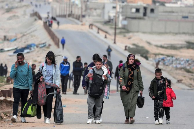 People fleeing the Al-Shifa hospital compound and its vicinity in Gaza City, reach the central part of the Gaza Strip on Mar. 21, 2024. (AFP)