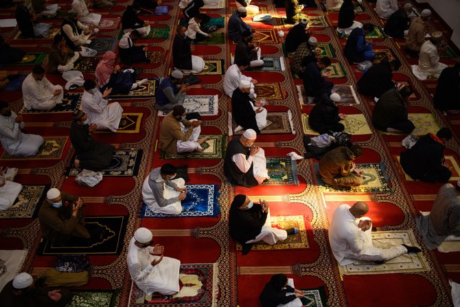 Muslims gather to perform the Eid Al-Fitr prayer, which marks the end of the holy month of Ramadan, at Bradford Central Mosque in Bradford, northern England on May 13, 2021. (AFP)