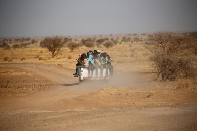 Migrants crossing the Sahara desert into Libya ride on the back of a pickup truck outside Agadez, Niger, in May 2016. (Reuters/File)