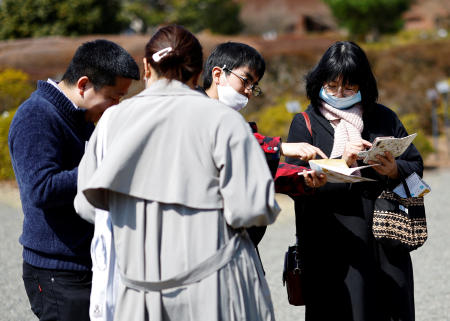 Participants take part in a match-making event using mystery solving game, which is organized by Tokyo metropolitan government at Jindai Botanical Gardens in Tokyo, March 20, 2024. (Reuters)