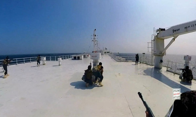 Houthi fighters take positions on the deck of the Galaxy Leader cargo ship in the Red Sea. (Reuters/File)