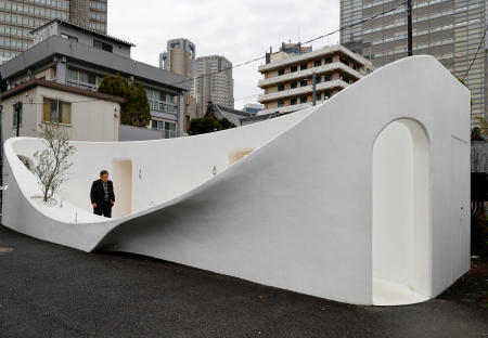 A participant looks around a public toilet which was redesigned as part of a project to transform public toilets into restrooms that can be used comfortably by everyone, during a Tokyo Toilet Shuttle Tour, at Shibuya ward, in Tokyo, Japan April 4, 2024. (Reuters)
