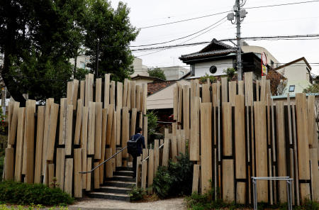 Foreign tourists get their photos taken in front of a public toilet which was redesigned as part of a project to transform public toilets into restrooms that can be used comfortably by everyone, during a Tokyo Toilet Shuttle Tour, at Shibuya ward, in Tokyo, Japan April 4, 2024. (Reuters)