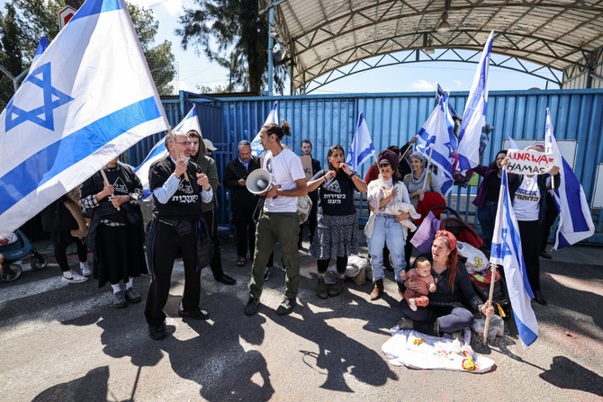 Right-wing Israeli protesters gather outside the West Bank field office of the UNRWA, the United Nations relief agency for Palestinians, in Jerusalem on March 20, 2024, to demand its closure. (AFP)