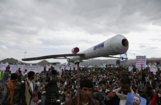 A member of the Houthis carries a mock drone in support of attacks on Red Sea shipping, Sanaa, Yemen, Feb. 16, 2024. (Reuters)