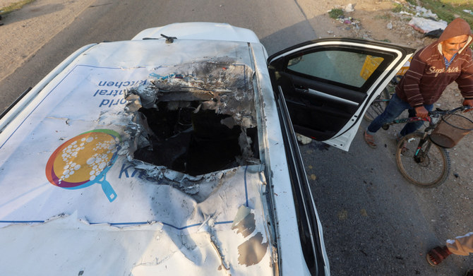 A Palestinian man rides a bicycle past a damaged vehicle where employees from the World Central Kitchen (WCK), including foreigners, were killed in an Israeli airstrike in Deir Al-Balah, in the central Gaza, Strip April 2, 2024. (REUTERS)