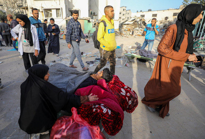 A Palestinian woman reacts as she sits amid the rubble of Gaza's Al-Shifa hospital after the Israeli military withdrew from the complex housing the hospital on April 1, 2024. (AFP)