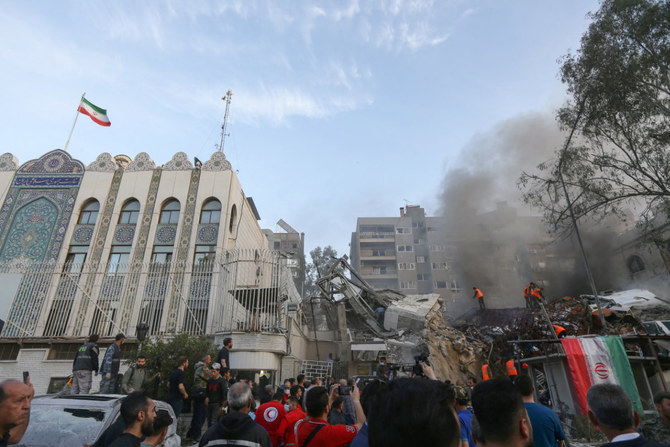 Syrian emergency and security personnel search the rubble at the site of an Iranian embassy annex building in Damascus that was hit in an Israeli airstrike on April 1, 2024. At least 13 people were killed, including two Iranian Revolutionary Guards generals and five personnel from the force. (AFP/File)