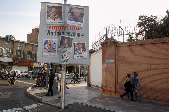 A banner displaying pictures of Israeli army officials with their faces encircled by a red crosshair icon, hang in Tehran on April 2, 2024 following an Israeli strike in Damascus that demolished the consular annex of Iran's embassy, killing at least 13 people, including two Iranian Revolutionary Guards generals and five personnel from the force. (AFP)