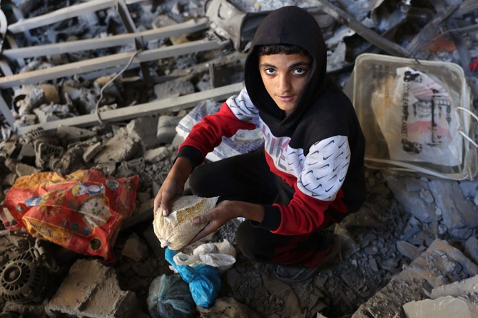 A Palestinian inspects the damage to the home of the Tabatibi family after Israeli bombardment in the Daraj Neighbourhood of Gaza on April 12, 2024, during the ongoing battles between Israel and the Palestinian Hamas movement. (AFP)