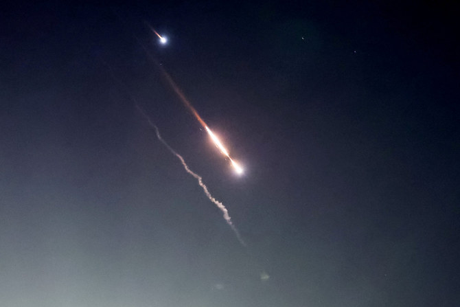 Objects are seen in the sky above Jerusalem after Iran launched drones and missiles towards Israel, in Jerusalem April 14, 2024. REUTERS/Ronen Zvulun