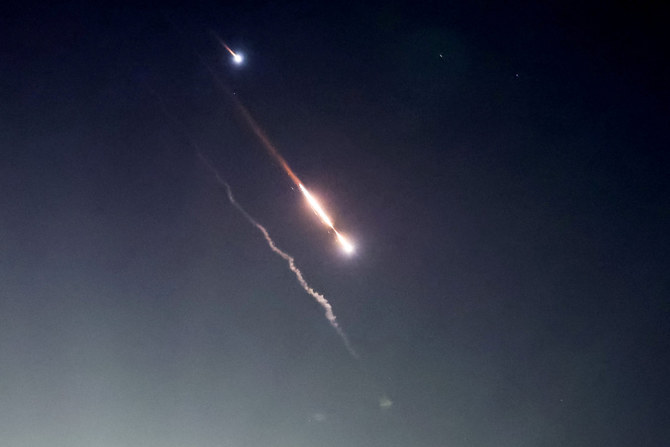 Objects are seen in the sky above Jerusalem after Iran launched drones and missiles towards Israel, in Jerusalem April 14, 2024. REUTERS/Ronen Zvulun