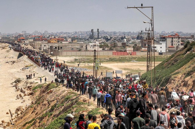 Displaced Palestinians take the coastal Rashid road to return to Gaza City as they pass through Nuseirat in the central Gaza Strip on April 14, 2024 amid the ongoing conflict in the Palestinian territory between Israel and the militant group Hamas. (AFP)