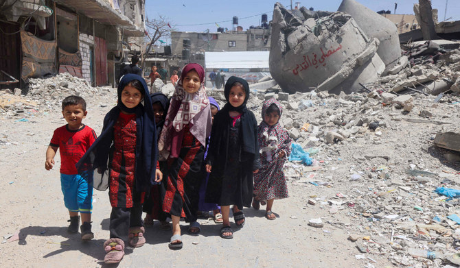 Palestinian children walk next to the ruins of Al-Farouq Mosque in Rafah in the southern Gaza Strip on Friday amid ongoing battles between Israel and Hamas. AFP The mosque was destroyed during Israeli bombardment. (AFP)