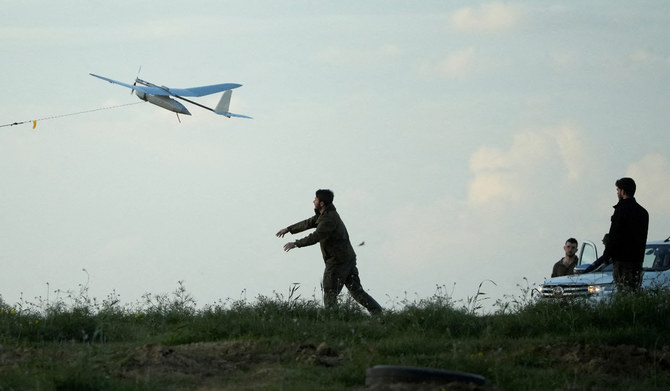 An Israeli soldier releases a drone near the border with Gaza, amid the ongoing conflict between Israel and the Palestinians, as seen from southern Israel, January 24, 2024. (REUTERS)