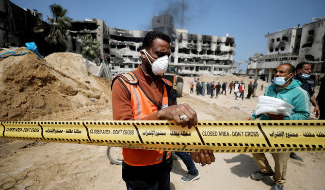 A man tapes off the area as rescuers and medics search for dead bodies inside the damaged Al Shifa Hospital after Israeli forces withdrew from the hospital and the area around it following a two-week operation, amid the ongoing conflict between Israel and Palestinian Islamist group Hamas, in Gaza City April 8, 2024. (REUTERS)