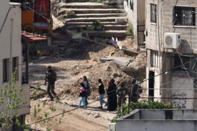 Israeli soldiers lead a Palestinian family out of their home during a raid in the Nur Shams refugee camp in the occupied West Bank on April 20, 2024. When it came to complaints against Israeli military abuses of Palestinian civilians, US officials usually look the other way, according to a former US State Department official. (AFP)