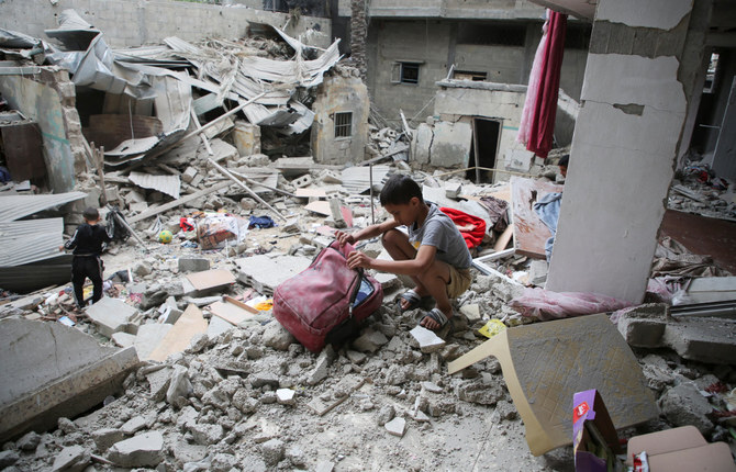 Palestinian children inspect the site of an Israeli strike on a house in Rafah, in the southern Gaza Strip, on April 27, 2024. (REUTERS)