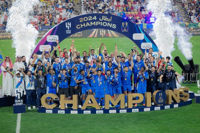 Al Hilal's Salem Al Dawsari lifts the trophy with teammates after winning the Saudi Super Cup final in Abu Dhabi. Reuters