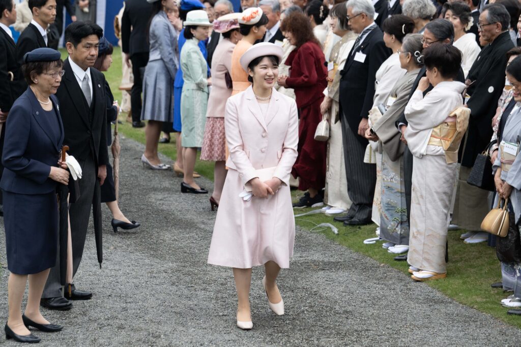 Japan's Princess Aiko, along with members of the royal family, walks to greet guests during the spring garden party at the Akasaka Palace imperial garden in Tokyo on April 23, 2024. (AFP)