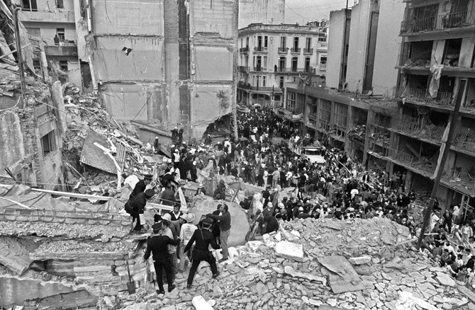 Rescuers search for people from the rubble of the building housing the Argentinian Israelite Mutual Association (AMIA in Spanish) that was demolished in a powerful bomb explosion in Buenos Aires on July 18, 1994. (Ali Burafi / AFP)