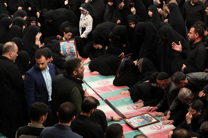 Relatives mourn over the coffins of seven Revolutionary Guard Corps members killed in a strike on the country’s consular annex in Damascus, which Tehran blamed on Israel, ahead of their funeral procession. (Khamenei.ir via AFP)