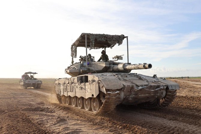 This picture taken from Israel near the border with the Gaza Strip shows Israeli military vehicles exiting Gaza on March 7, 2024. (File/AFP)