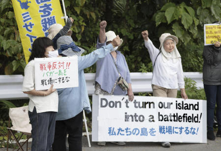 People protest against the visit by US Ambassador to Japan Rahm Emanuel near a military post of Japan Ground Self-Defense Force on Ishigaki Island in Okinawa prefecture, southern Japan Friday, May 17, 2024. (Kyodo News via AP)